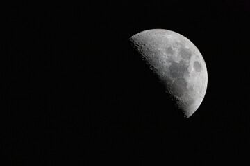 Wall Mural - crescent moon photographed with a telescope. the moon is at 50% luminosity