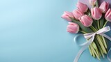 gift and pink tulips on blue background