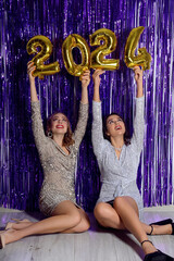 Sticker - Beautiful young women with figure 2024 sitting near violet tinsel