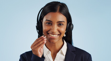 Wall Mural - Happy woman, portrait and headphones for call center or customer service against a blue studio background. Face of female person, consultant or agent smile with mic for online advice on mockup space