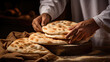 © ThisDesign - person skillfully folding traditional Arabic bread. generative ai