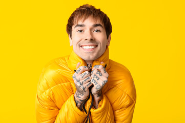 Sticker - Happy handsome young tattooed man on yellow background