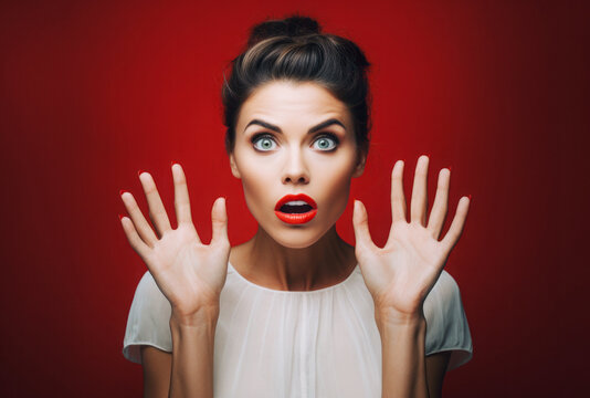 Beautiful woman with red lips expressing surprise and shock emotion with open mouth and big wide open eyes.