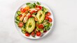 © CStock - Delicious salad with chicken, avocado and vegetables served on table,