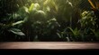 Wooden table top on blurred background of tropical garden with palm trees.