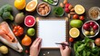 nutritionist crafting a healthy diet plan – top view of table with nutrient-rich foods and illustrations on healthy eating habits