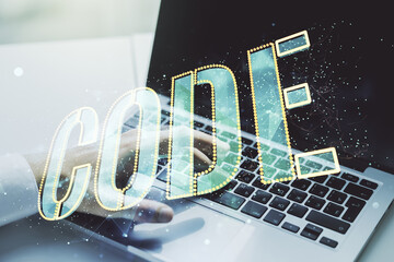 Wall Mural - creative code word sign and hands typing on laptop on background, international software development