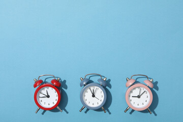 Wall Mural - Classic multicolored alarm clocks with on a blue background