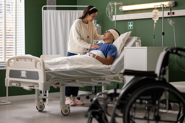 In the hospital room, the wife stands by her husband's side, offering solace. The man looks at his wife with gratitude and love in the hospital room