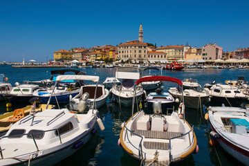 Wall Mural - Boats on the historic waterfront of the medieval coastal town of Rovinj in Istria, Croatia. Saint Euphemia Church is centre