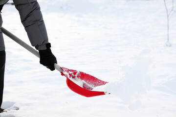 Wall Mural - Man removing snow with shovel outdoors, closeup