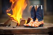 cowboy boots and patterned bandana by open flame