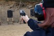 © Tylinek - police officers practice shooting a pistol at a target