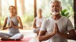 Meditating with group during yoga session. Quite sporty elder people contemplate mind and relax sitting in lotus poses in class. Physical and mental recreation with mindfulness