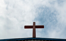 A Cross Under The Cloudy Sky