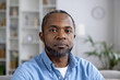 © Liubomir - Close-up portrait of an African-American man sitting at home, looking seriously and confidently at the camera.