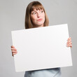 Young woman with an empty  advertising board