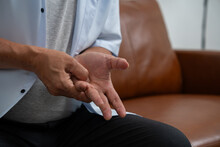Elderly Asian Male Patients Suffer From Numbing Pain In Hands From Rheumatoid Arthritis. Senior Men Massage His Hand With Wrist Pain. Concept Of Joint Pain, Rheumatoid Arthritis, And Hand Problems.