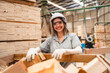 © chokniti - woman carpenter worker wearing safety uniform working to quality control checking of wooden products at workshop manufacturing. female technician making wooden in carpenter's shop industry warehouse.