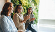 © Jacob Lund - Smiling businesswomen applauding in successful teamwork meeting