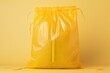 yellow plastic tied bag, against a matching yellow background, exuding a monochromatic aesthetic