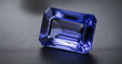 A stunning tanzanite gem on a neutral background, showcasing its exquisite color and clarity.