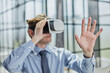 © Katsiaryna - businessman in virtual reality headset in the office