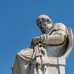 Wall Mural - Plato marble statue, the ancient Greek philosopher, isolated on plain sky background. Travel to Athens, Greece.