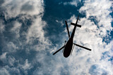 Fototapeta  - helicopter silhouette in dark clouds