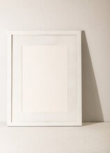 White Frame Leaning On White Plaster Wall
