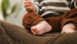 closeup of baby feet in knitted brown pants