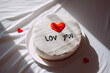 Valentine's Day cake with red heart and I love you inscription. 