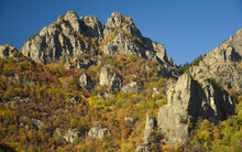 Cozia Mountains During Autumn. From The Wild Beech Forests, Numerous Pointed Cliffs Are Rising To The Sky. The Eroded Rocks Are Sharp. Carpathia, Romania.