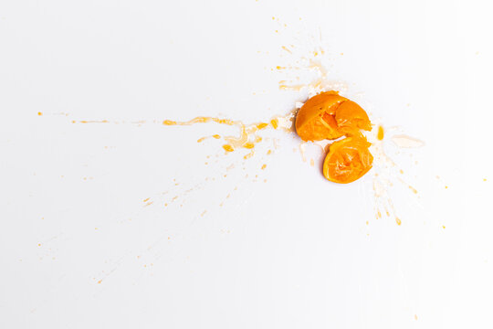 Small orange smashed on a white backdrop