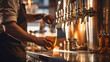 Close shot of a man filling glass of beer on a tap in a bar
