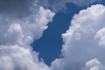 There is a large, cumulus cloud in the blue sky. Close-up