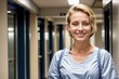 medical professional student in a hospital hallway wearing scrubs and smiling for portrait