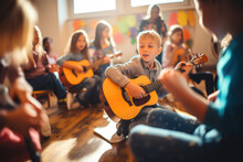Young Children Playing Guitar In Classroom