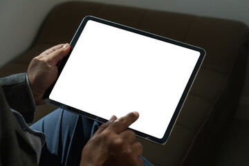 A businessman holds a mockup. iPad digital tablet with blank screen Mockup replaces your design mockup in the office.