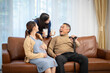 © SKW - family father two pregnant daughter sitting together drink milk excited about having grandchildren