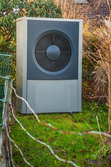 Wall Mural - Air source heat pump installed outside in a garden