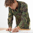 © Duncan M/peopleimages.com - Soldier writing on map, army plan of attack and hero in uniform with operation goals for mission in war. Military man on white background, strategy document with target and battle logistics in studio