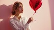 woman with a heart shaped red balloon, happy valentines day