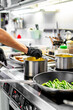 © pavel siamionov - Chef hands cooking cheese sauce in the restaurant kitchen