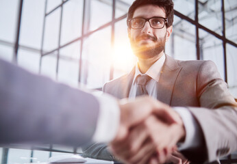 Wall Mural - Handshake of two businessmen who enters into the contract to develop a new software to improve business service at a company.