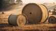© Usman - Misty morning sunrise with hay bails in a field.
