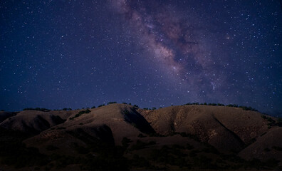 Wall Mural - Landscape with Milky Way. Night sky with stars on the mountain,