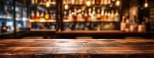 Inviting Bar. Wooden Table And Retro Counter Create Nostalgic And Comfortable Atmosphere. Dimly Lit Space Is Perfect For Night Out With Soft Glow Of Lights Setting Relaxed Mood