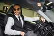 © LIGHTFIELD STUDIOS - appealing elegant man in stylish attire with sunglasses behind steering wheel, business concept
