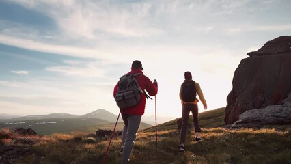 Aufkleber - Two happy young hikers goes uphill at sunset mountains